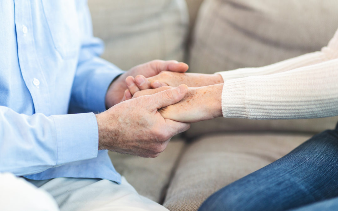 Holding hands with elderly person